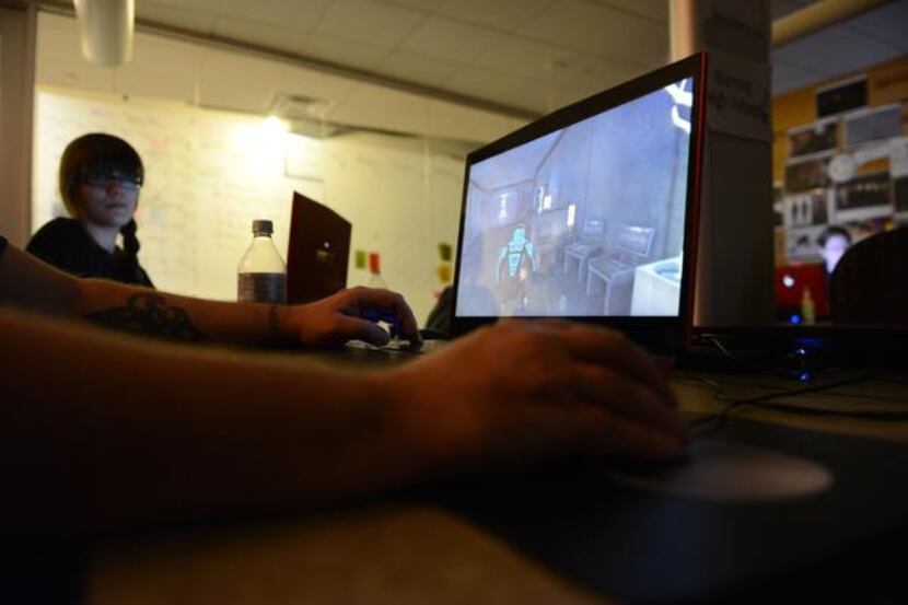 Instructor Michael McCoy tests a video game, Identity, created by students at Southern...