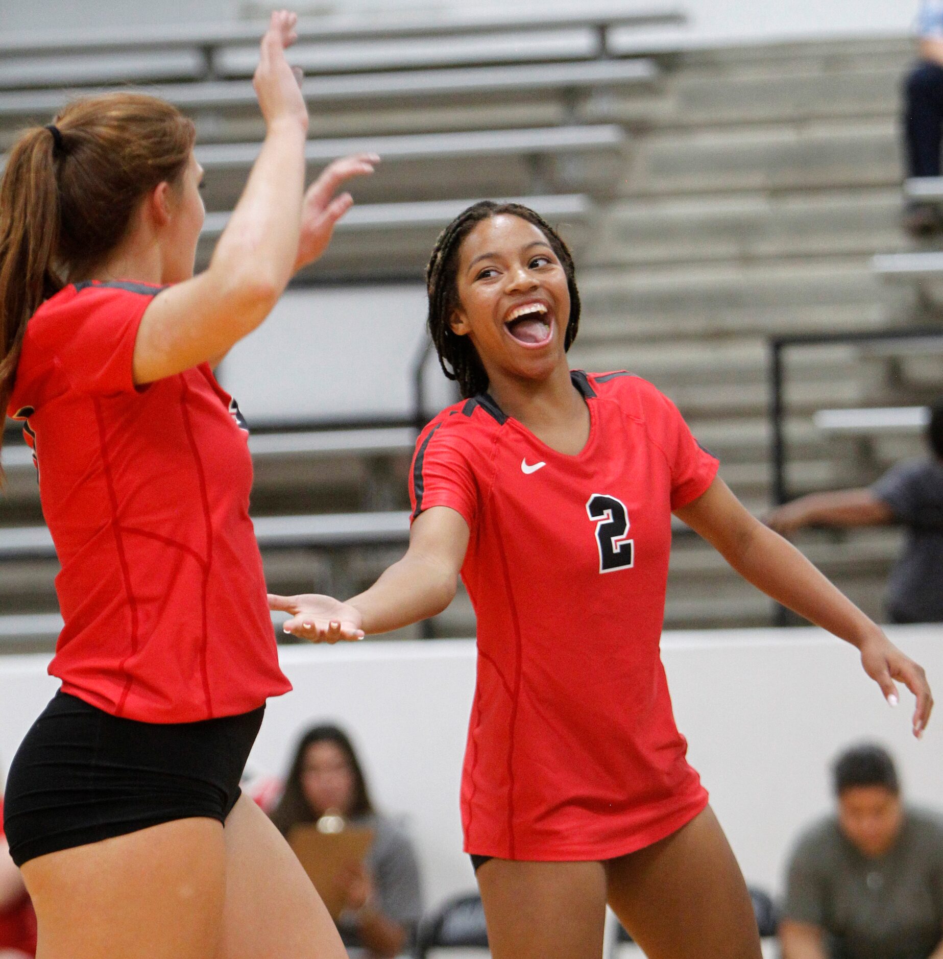 Arlington Martin's Aubrey Wright (2), right, celebrates with teammate Zella Baresh (3) after...