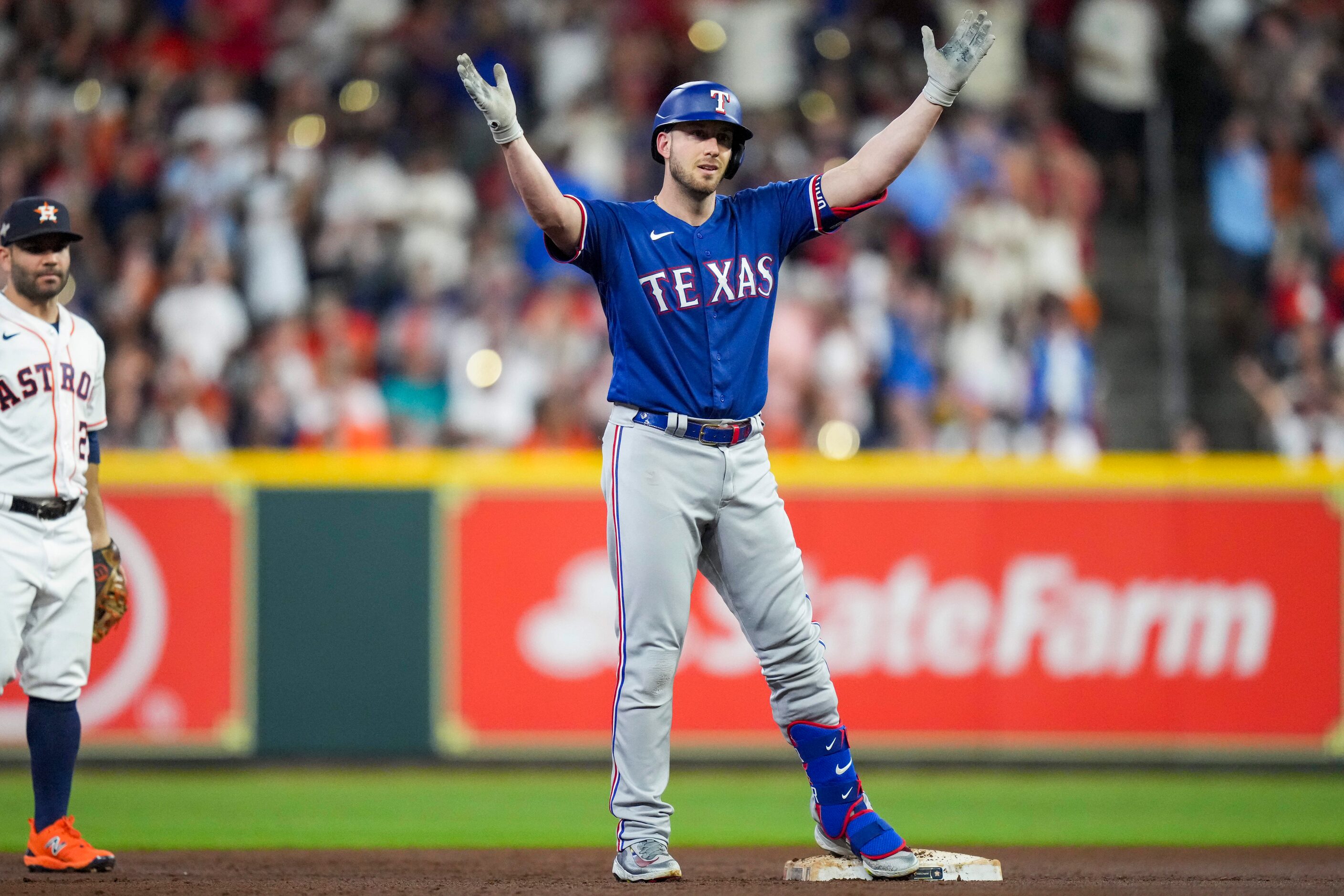 Texas Rangers designated hitter Mitch Garver celebrates on second base as Houston Astros...