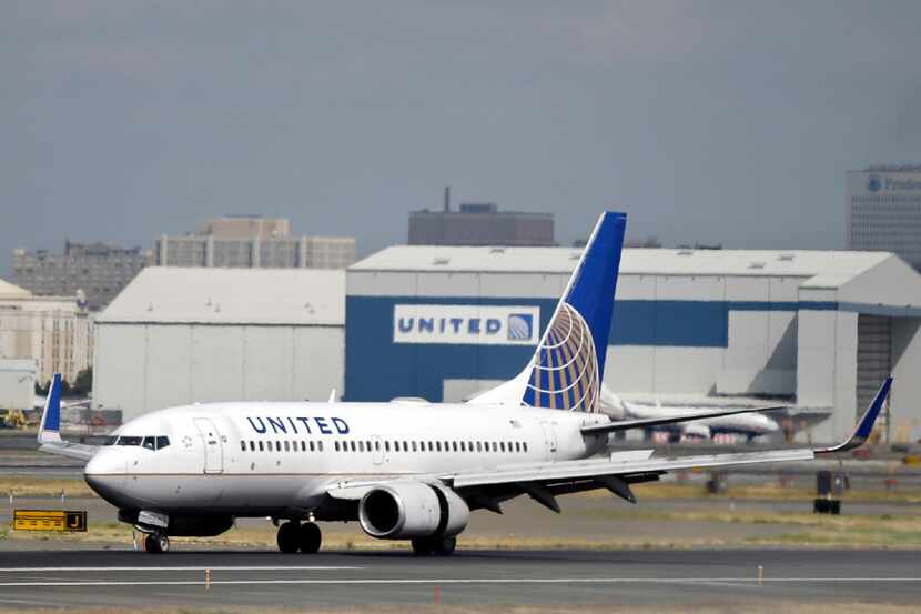 FILE - In this Sept. 8, 2015, file photo, a United Airlines passenger plane lands at Newark...