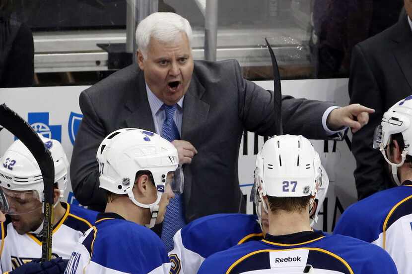 St. Louis Blues head coach Ken Hitchcock gives instructions during a timeout of an NHL...