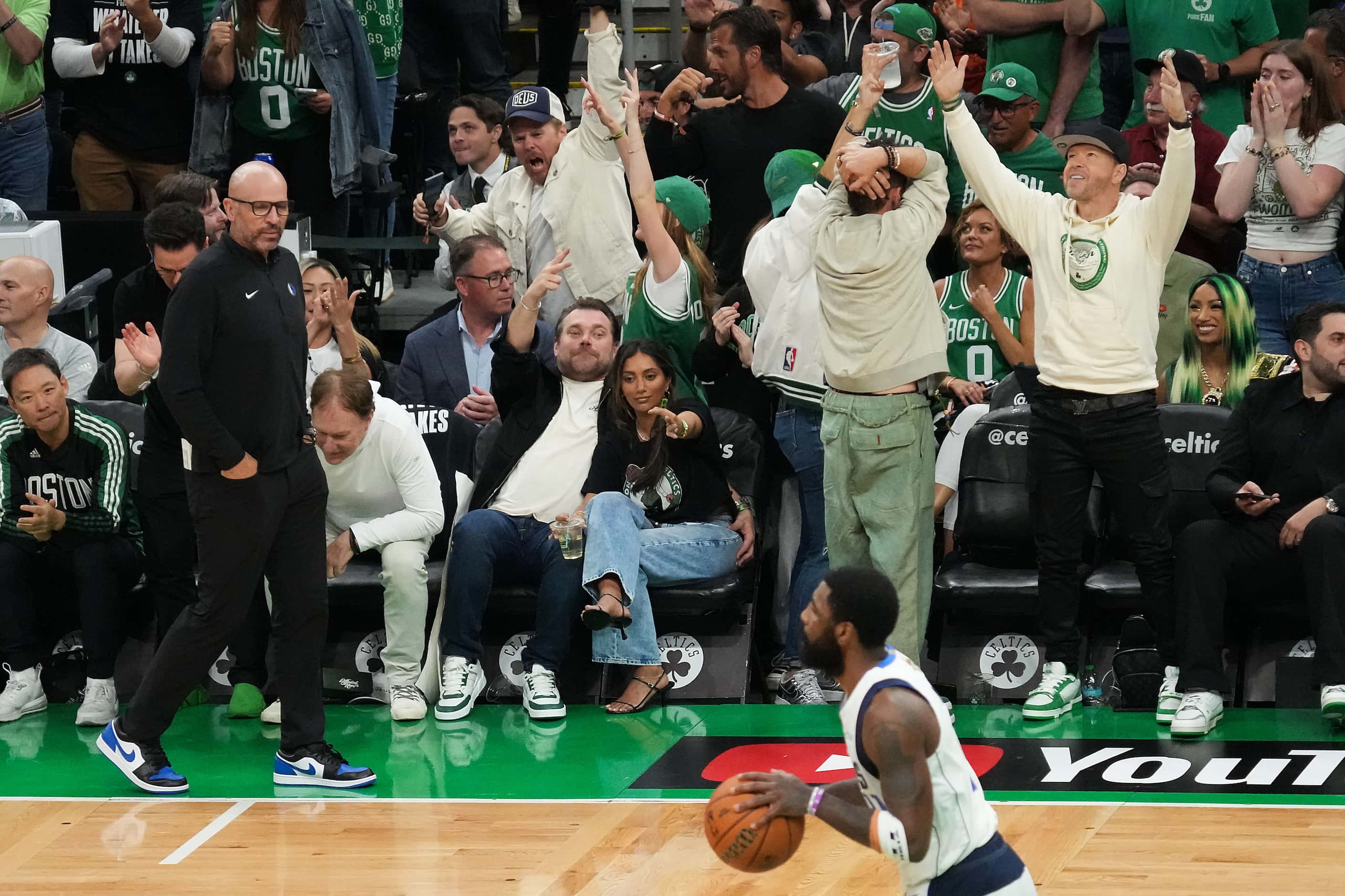 Boston Celtics fan, including actor Donnie Wahlberg (right) celebrate a basket as Dallas...