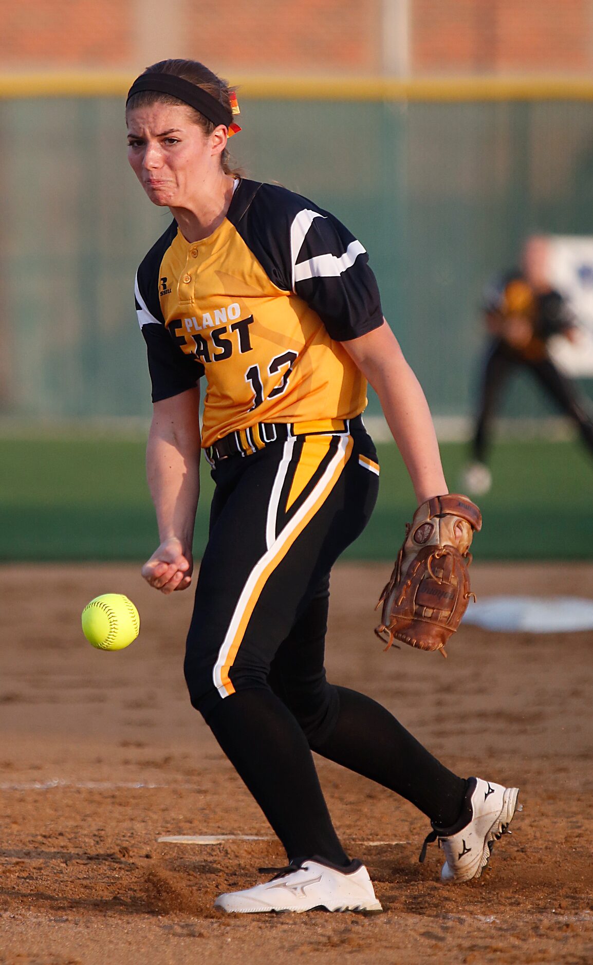 The Plano East High School varsity softball pitcher Grace Canny (13) delivers a pitch during...