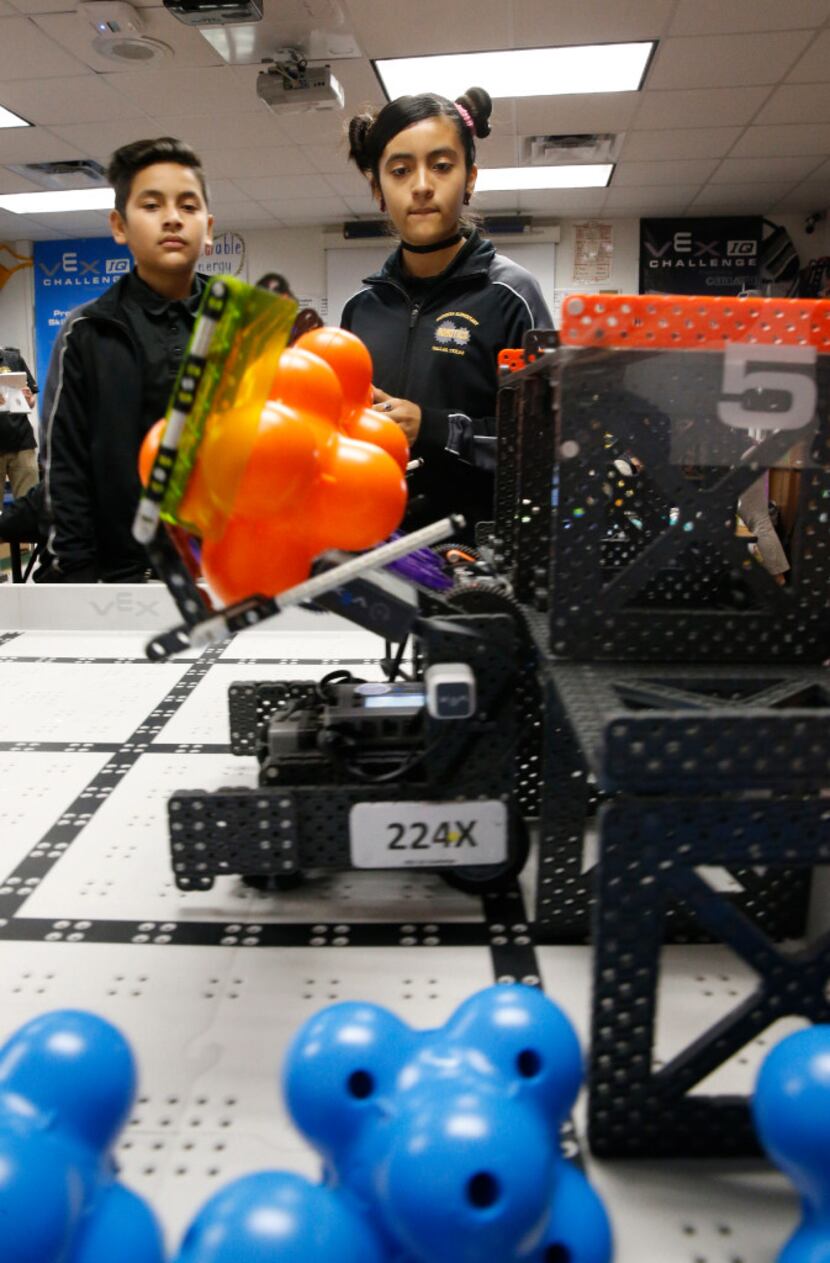 Abelino Graciano, 11, (left) and Keyri Fernandez, 11, use Wildbot to move around modules for...