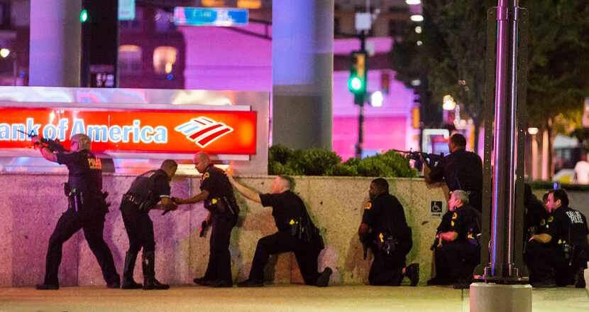 Dallas Police respond after shots were fired at a rally in downtown Dallas on Thursday, July...