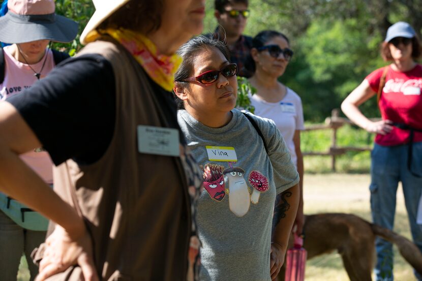 Vina Galindo (center), wears a custom made fungi shirt during the North Texas Mycological...