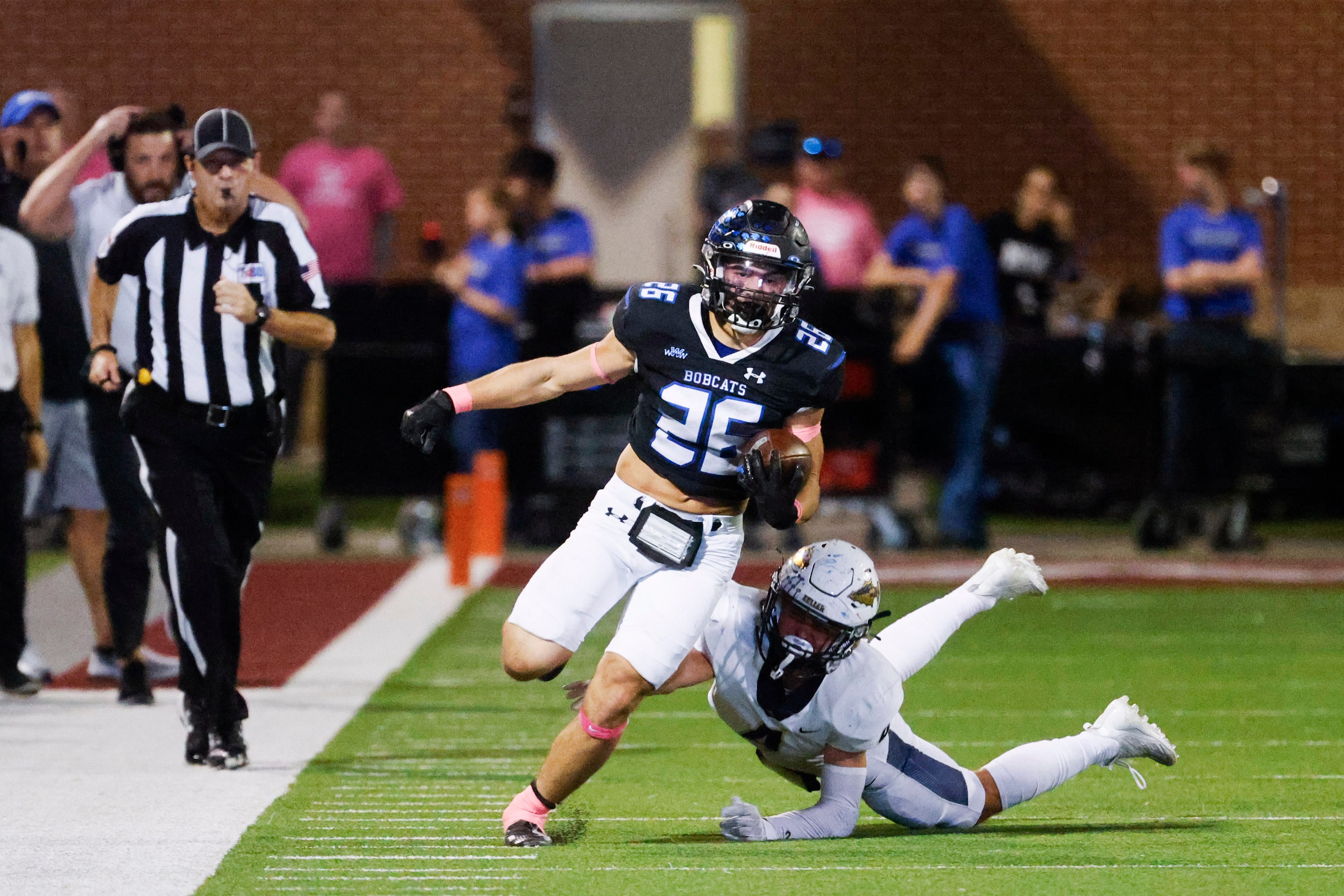 Byron Nelson’s Tucker James (26) runs past Keller high’s Landon Drilling (back) as he scores...