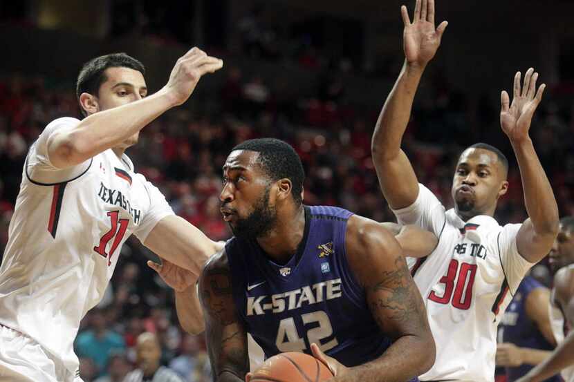 Kansas State's Thomas Gipson (42) is defended by Texas Tech's Dejan Kravic (11) and Jaye...