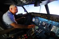 Kevin Sayre with his flight simulator he built in his garage, in Dallas,Texas, Wednesday,...