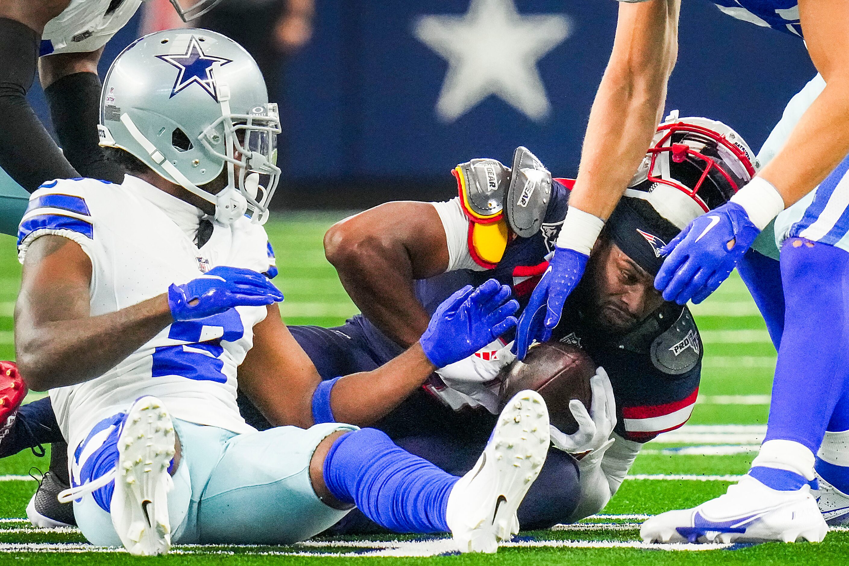 New England Patriots wide receiver JuJu Smith-Schuster (7) loses his helmet as he is brought...