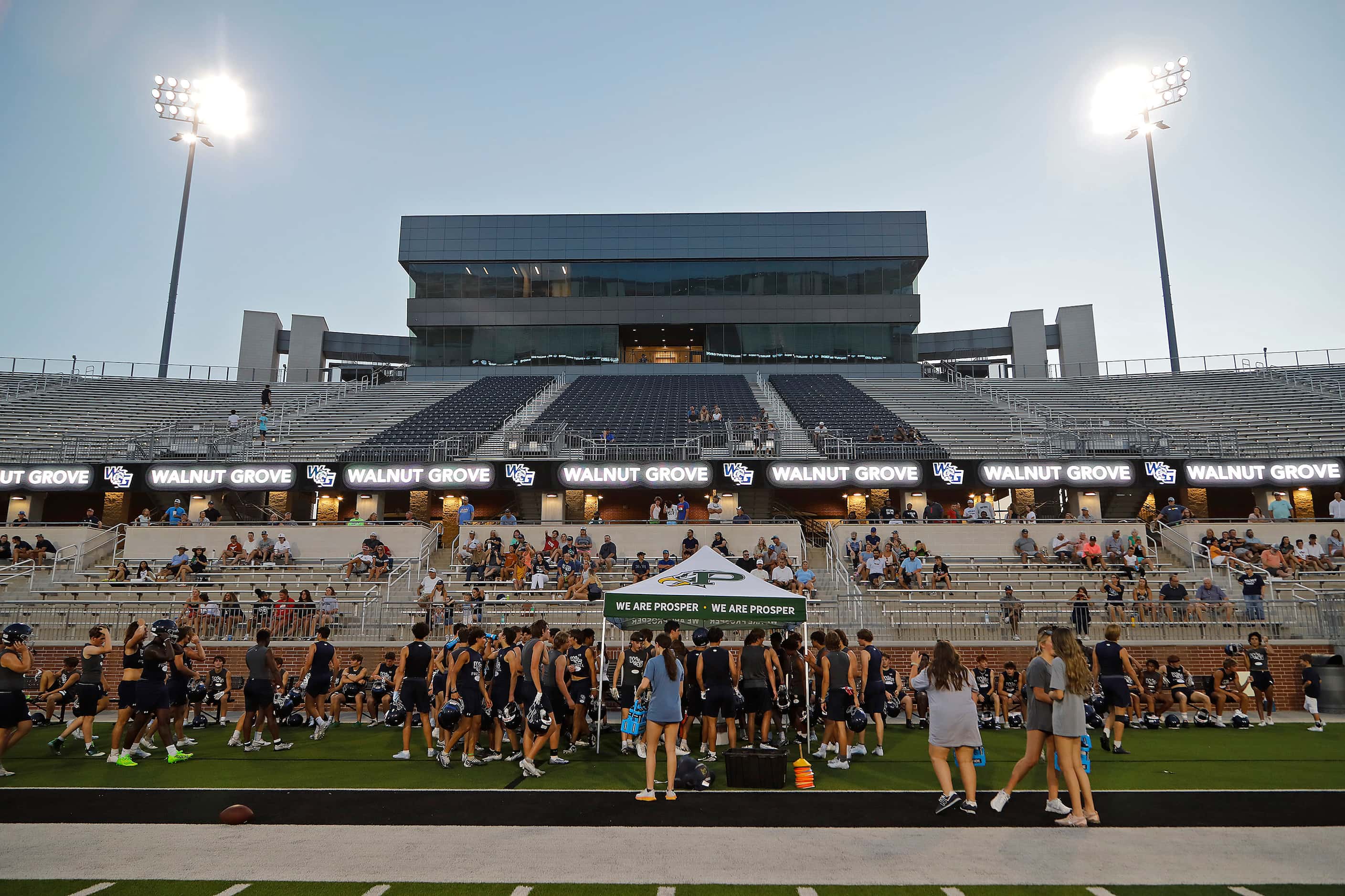 The team takes a break as Walnut Grove High School held their first football pactice on...