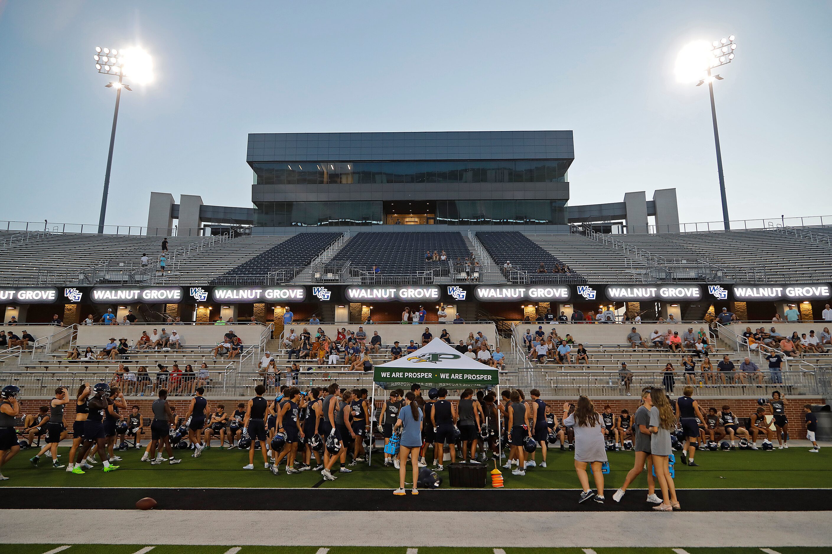 The team takes a break as Walnut Grove High School held their first football pactice on...