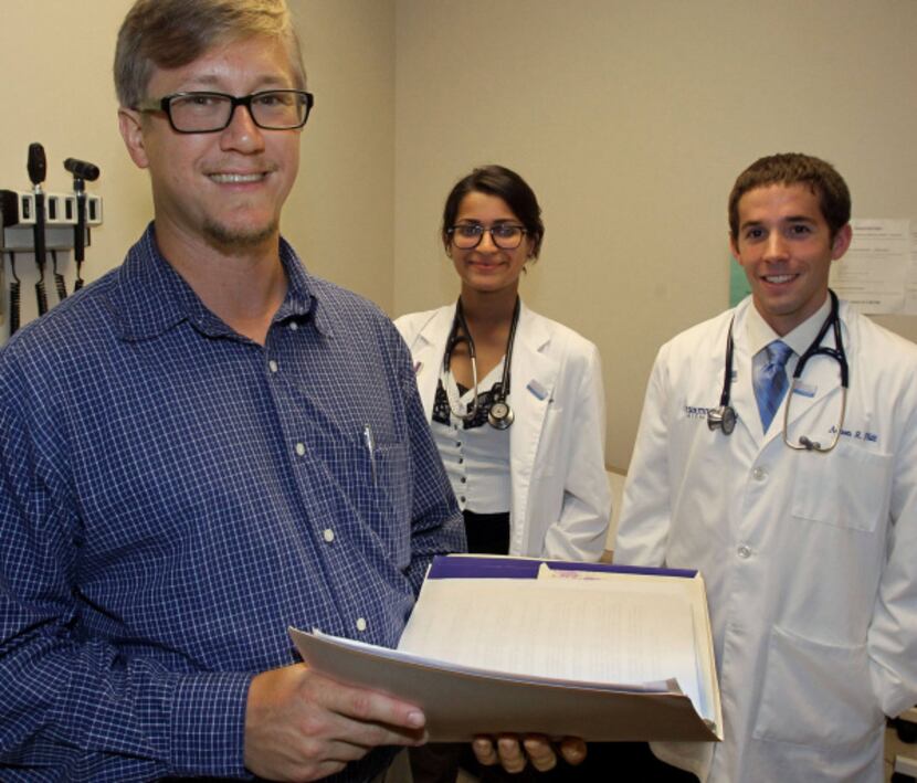 Justin Beatty of Denton, a first-year medical student at UT Southwestern, works at a free...
