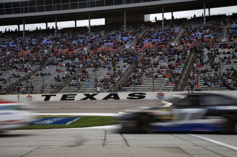 Cars pull into the pit during the NASCAR Sprint Cup Series at Texas Motor Speedway in Fort...