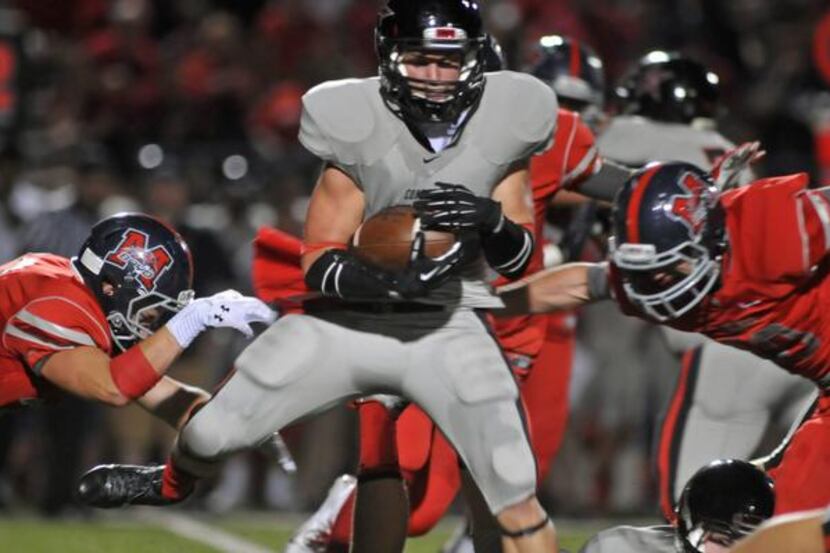 
Coppell’s Gavin McDaniel spins between defenders during a 49-24 win over McKinney Boyd.
