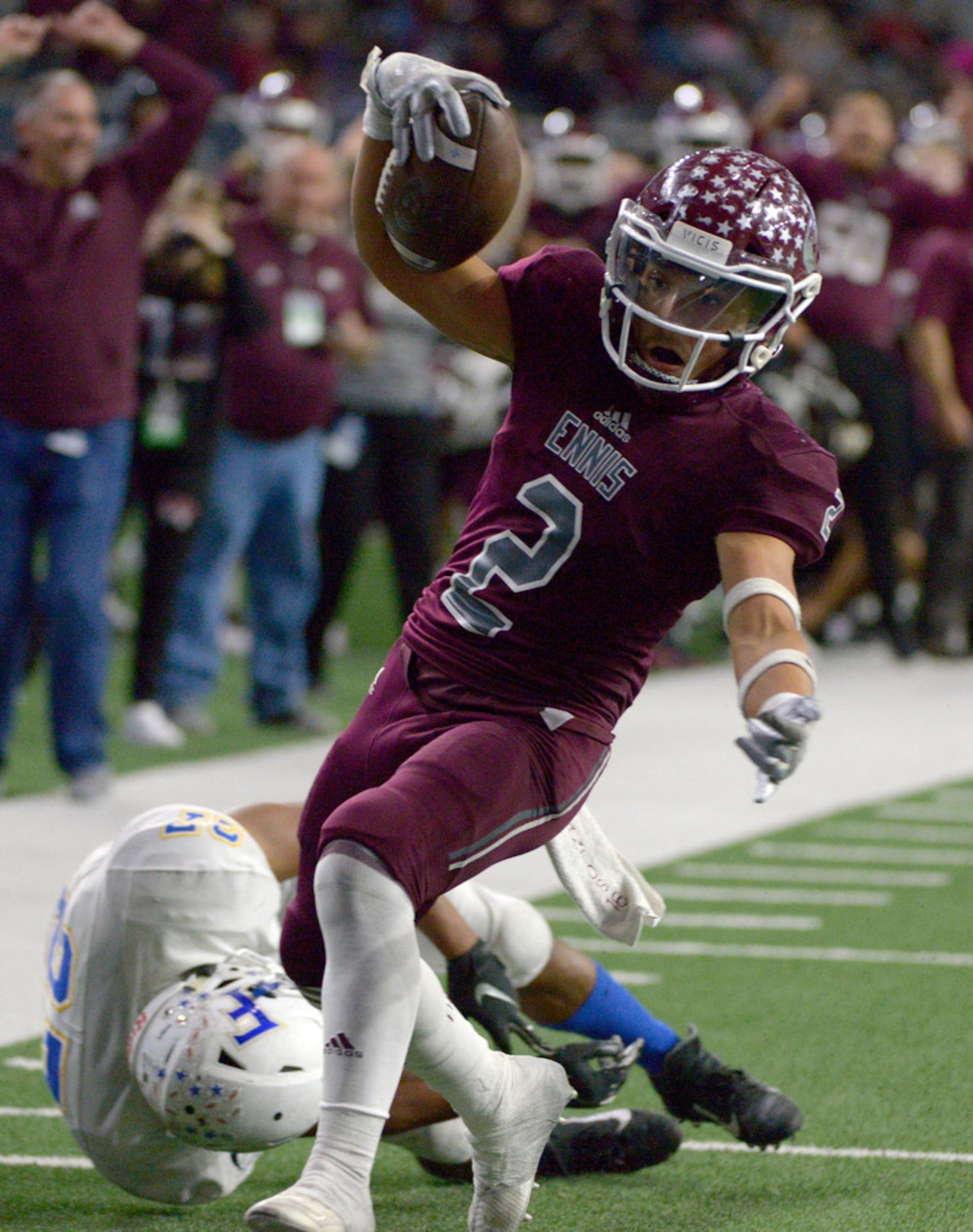 Ennis' Dyllan Santos (2) runs through a tackle attempt by Frisco's Aaron Taylor to score a...