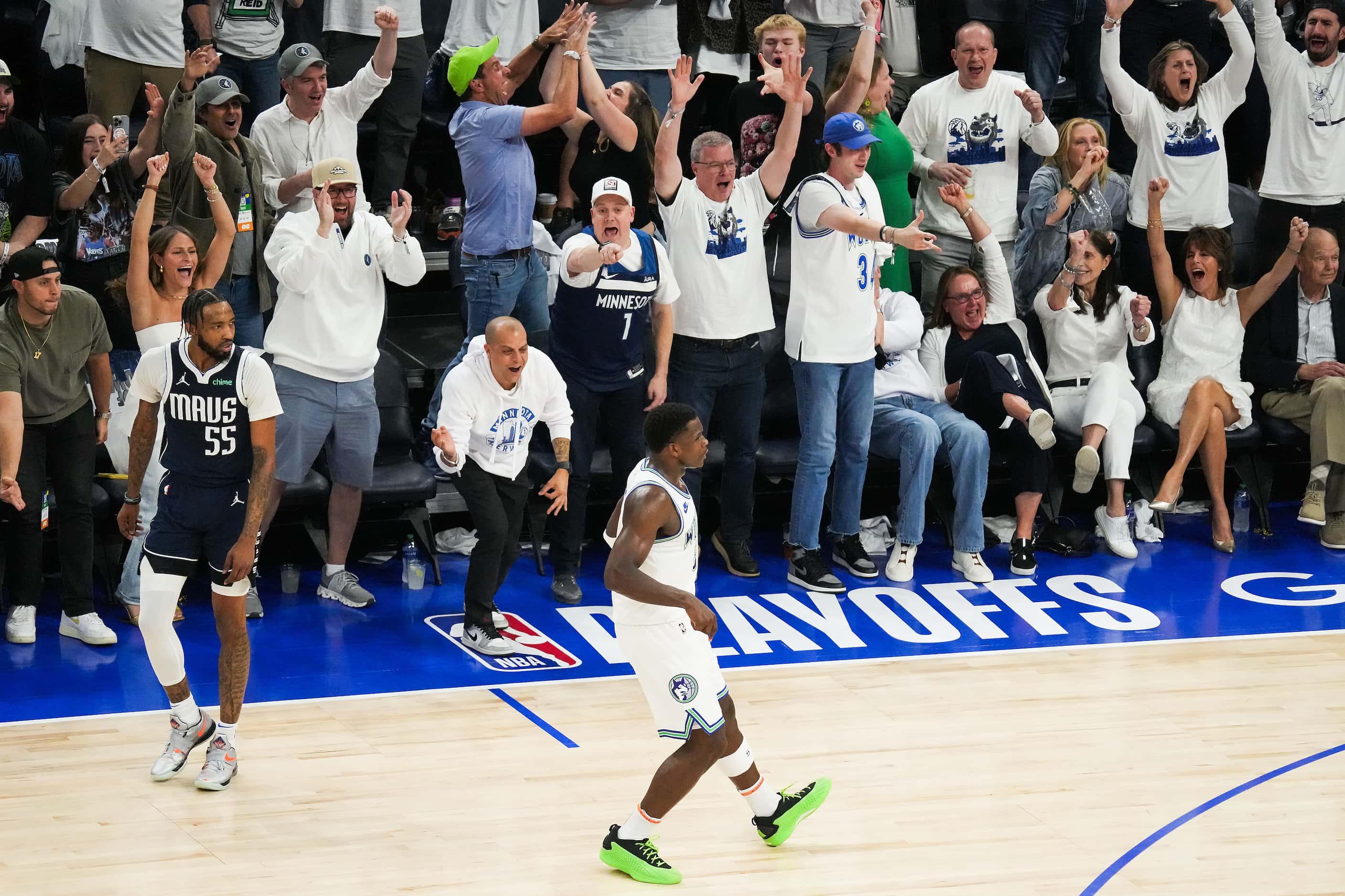 Minnesota Timberwolves fans cheer a 3-pointer by Timberwolves guard Anthony Edwards (5) as...