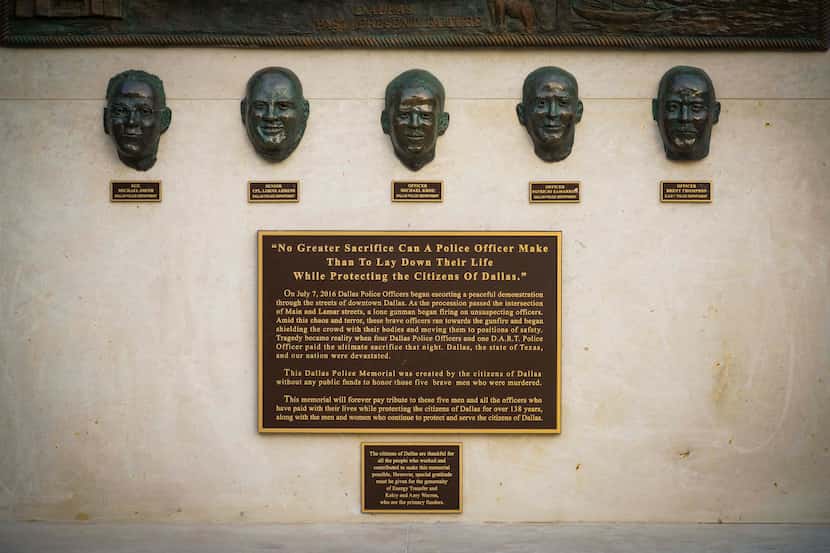 A memorial outside Dallas police headquarters honors the five officers — four Dallas police...