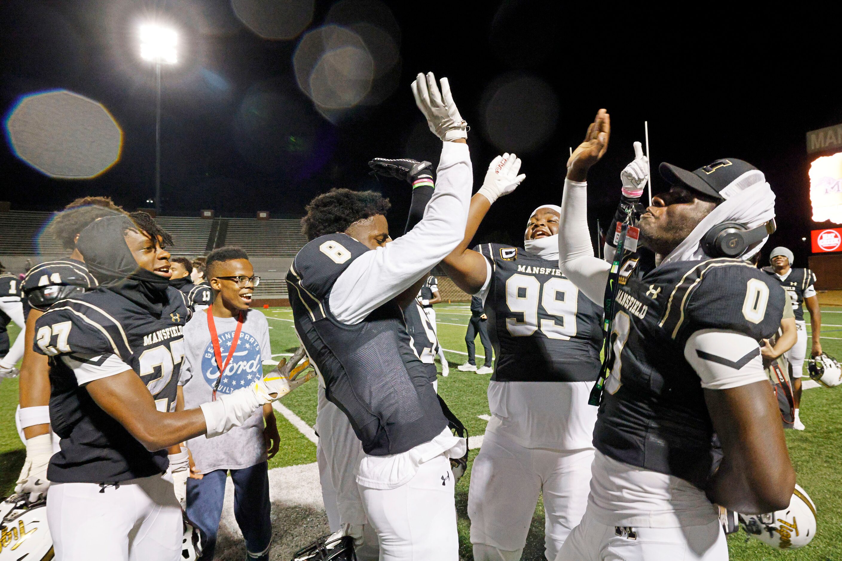 Mansfield players celebrate their victory against Weatherford after a high school football...