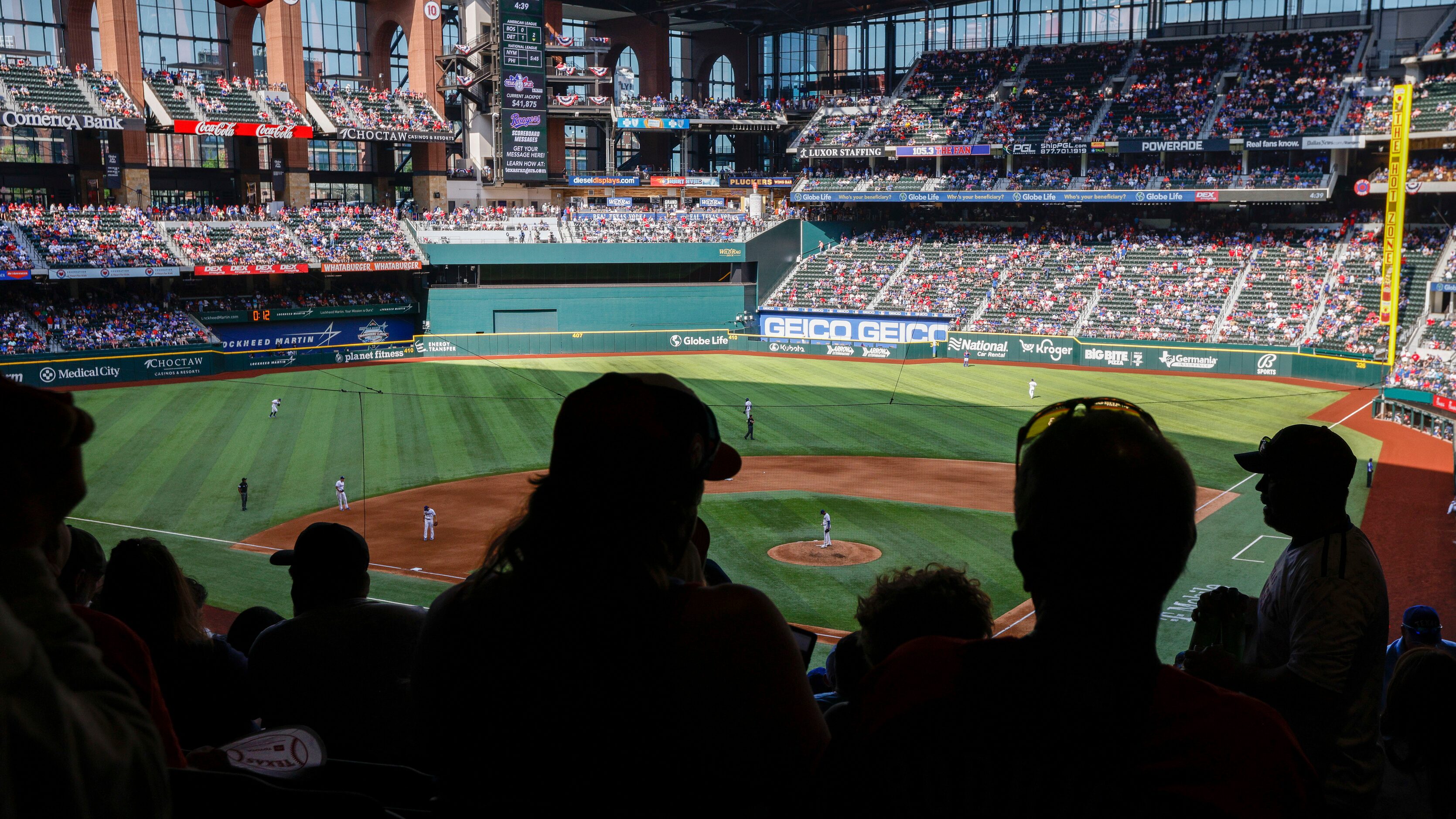 Baseball fans watch the Texas Rangers’ home opener against the Colorado Rockies at Globe...