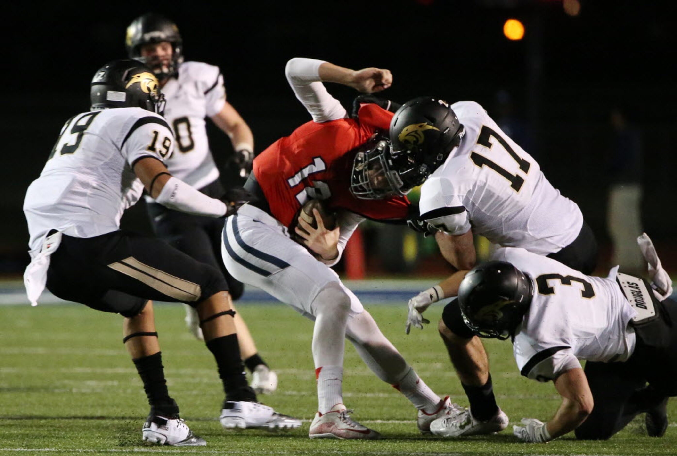 McKinney Boyd quarterback Grant Restmeyer (12) is sacked by Plano East defensive end Michael...