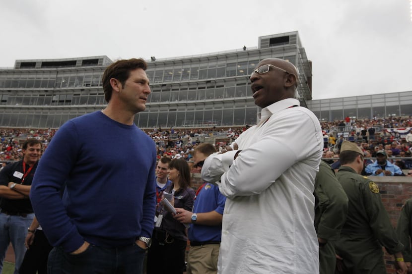 Former SMU players Craig James, left, and Eric Dickerson of the "Pony Express" watch from...
