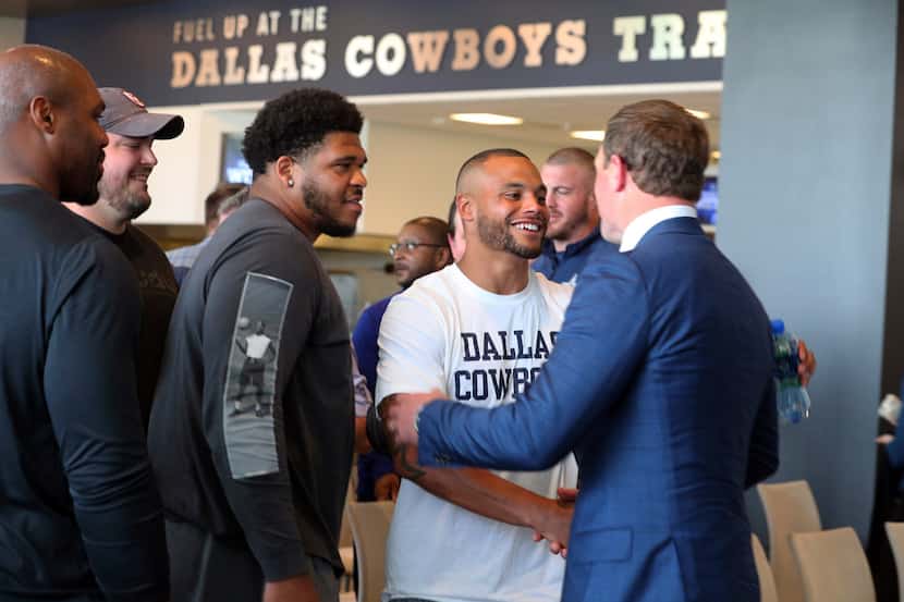 Retiring Dallas Cowboys tight end Jason Witten shakes hands with quarterback Dak Prescott as...