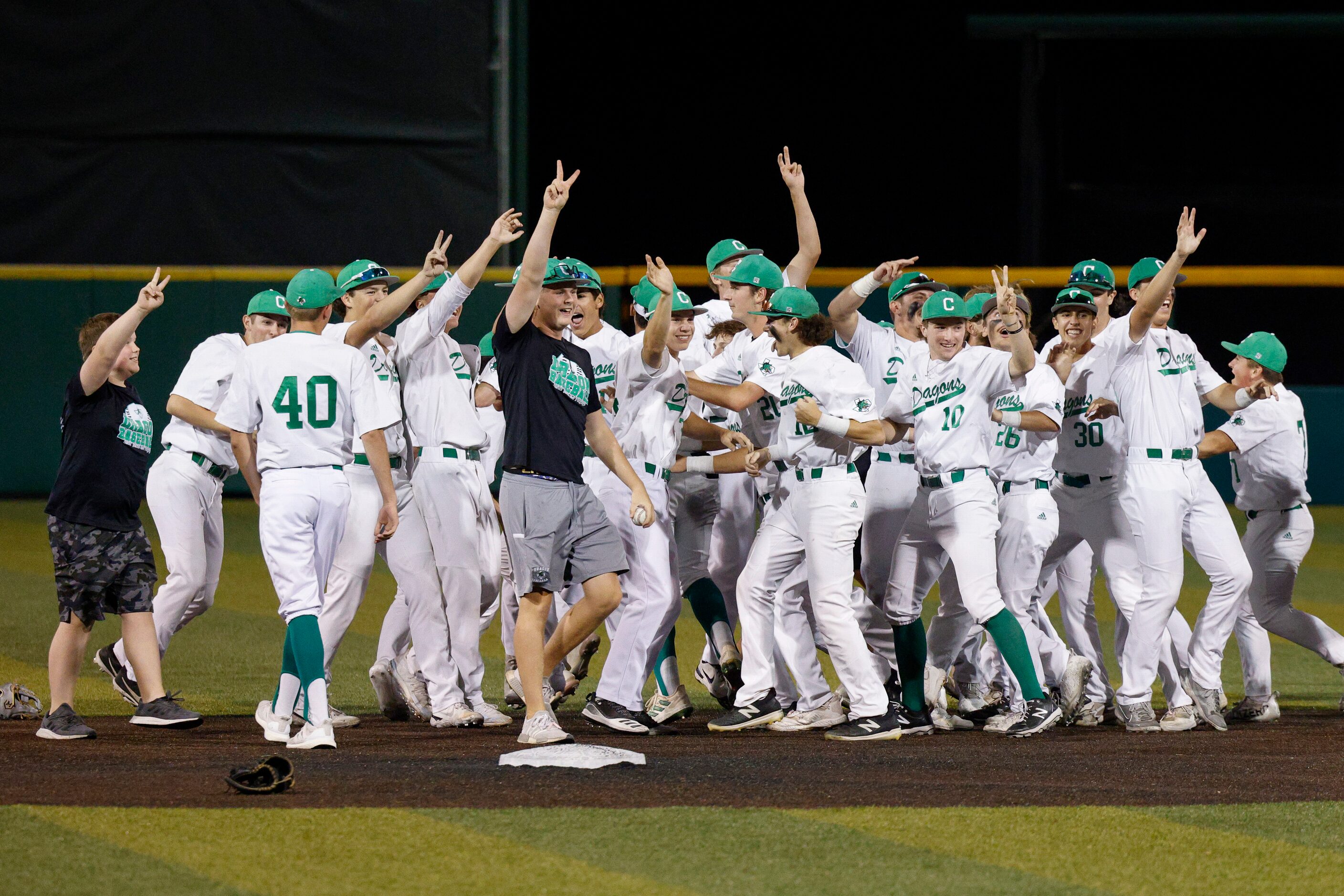 Southlake Carroll players celebrate after winning the Class 6A Region I final series at The...