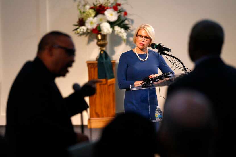  Dallas County District Attorney Susan Hawk (center) listens to an imampassioned message by...