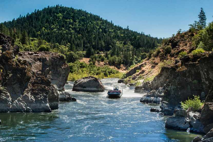 Guests zip through Hellgate Canyon on custom water vehicles on  the Hellgate Jetboat...