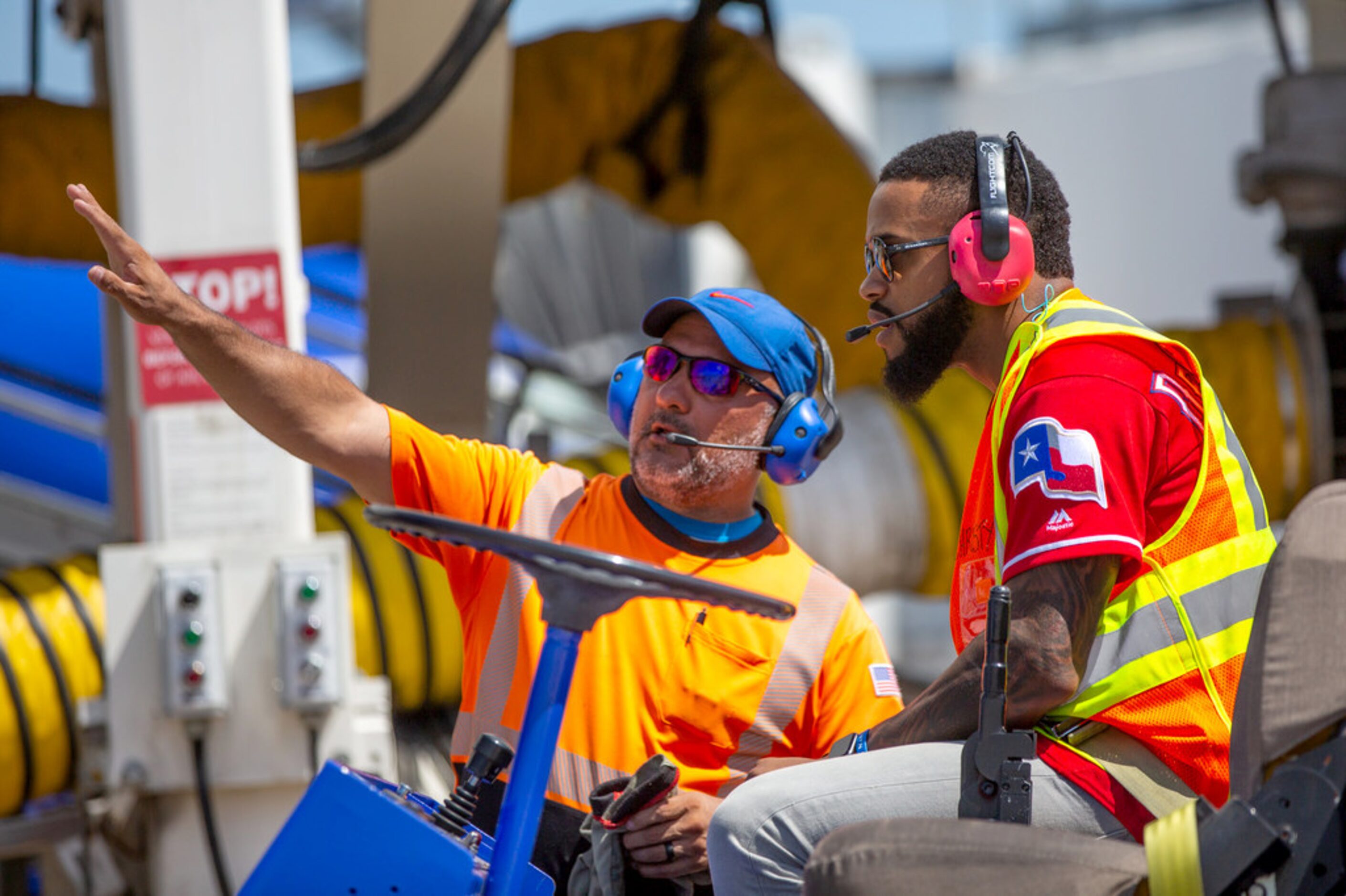 Texas Rangers center fielder Delino DeShields Jr. (right) listens to ramp agent Orlando...