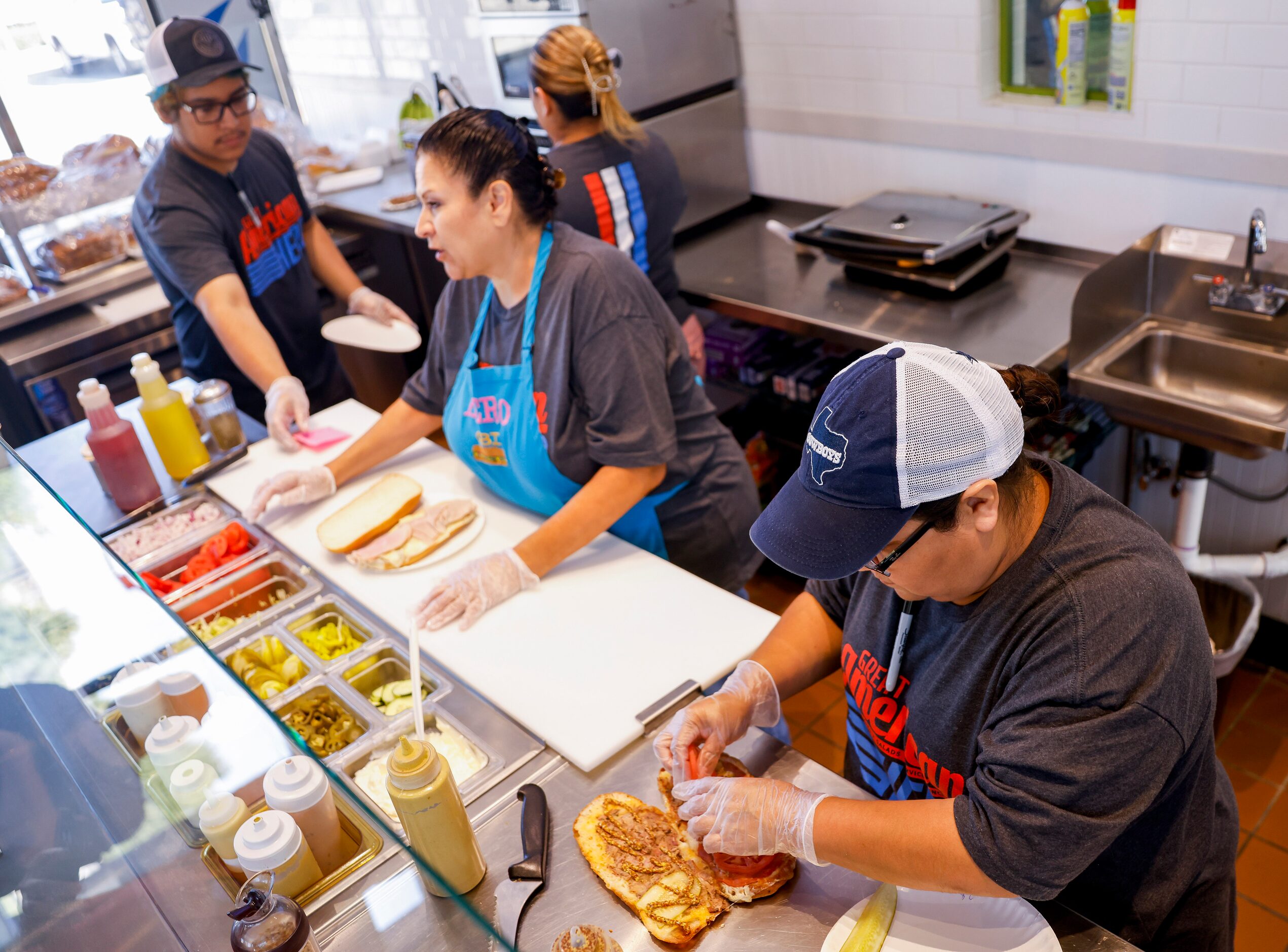 (From left) Workers Jonathan Gutierrez, Nancy Obregon and Andrea Peters help fulfill orders...