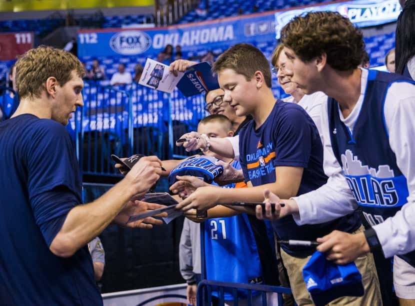 Dallas Mavericks forward Dirk Nowitzki (41) signs autographs for fans before game 5 of their...
