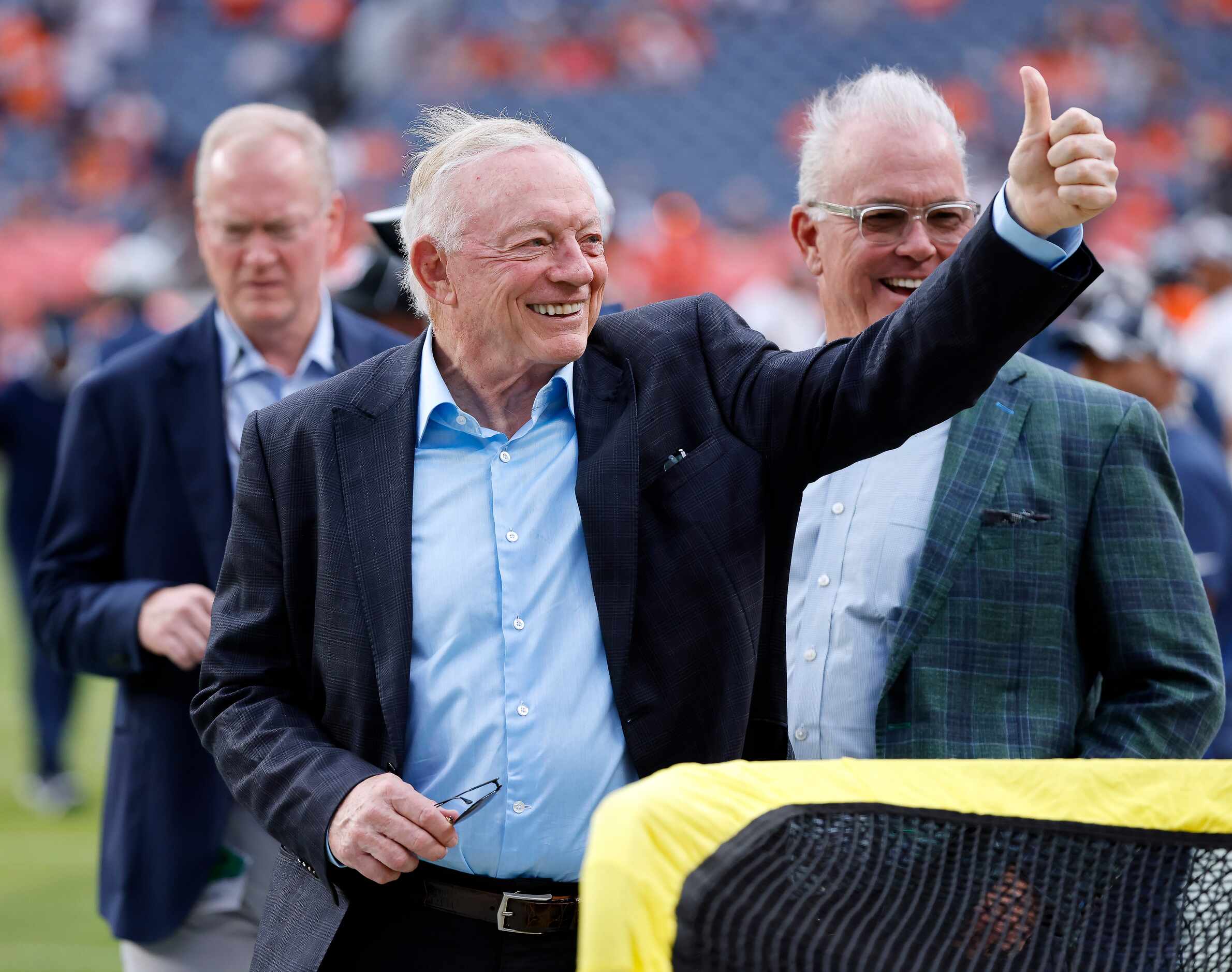 Dallas Cowboys owner Jerry Jones acknowledges the cheers from fans as he and his sons Jerry...
