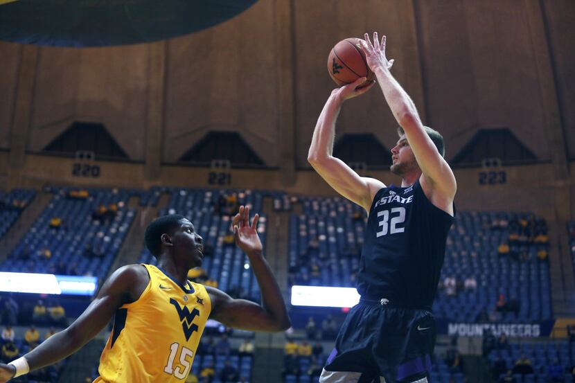 Kansas State forward Dean Wade (32) shoots while defended by West Virginia forward Lamont...