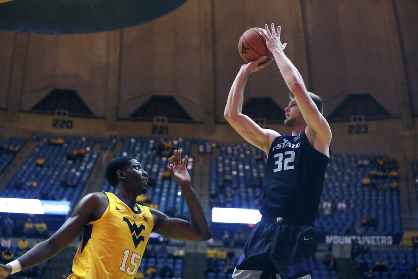 Kansas State forward Dean Wade (32) shoots while defended by West Virginia forward Lamont...