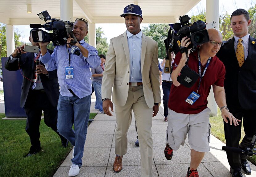 Members of the media scramble to get in front of Byron Jones, the Dallas Cowboys first-round...