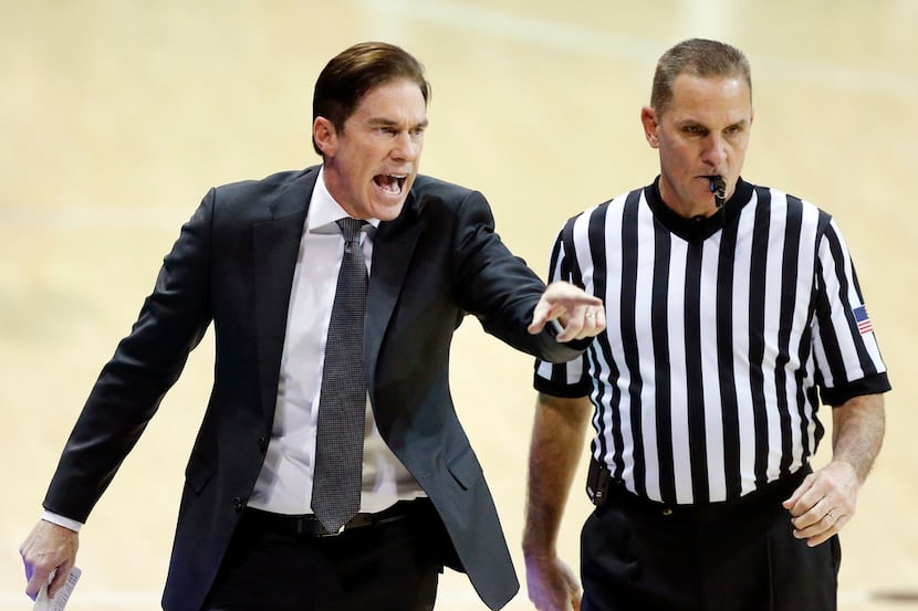 Southern Methodist Mustangs head coach Tim Jankovich is upset with the baseline official...
