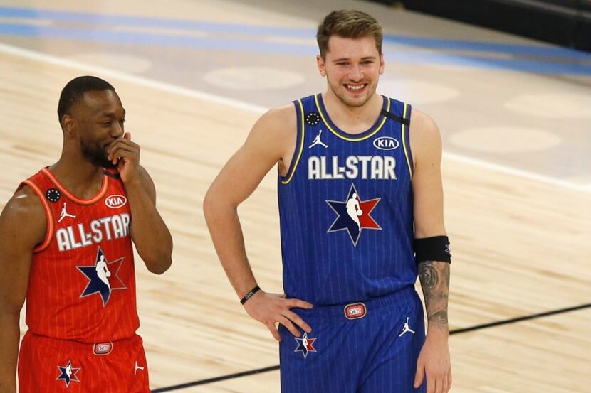 Team LeBron's Luka Doncic (2) and Team Giannis' Kemba Walker (24) share a laugh during a...