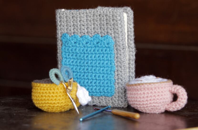 Items the that Meredith Crawford has crocheted and knitted are coffee cups, a cover for her...