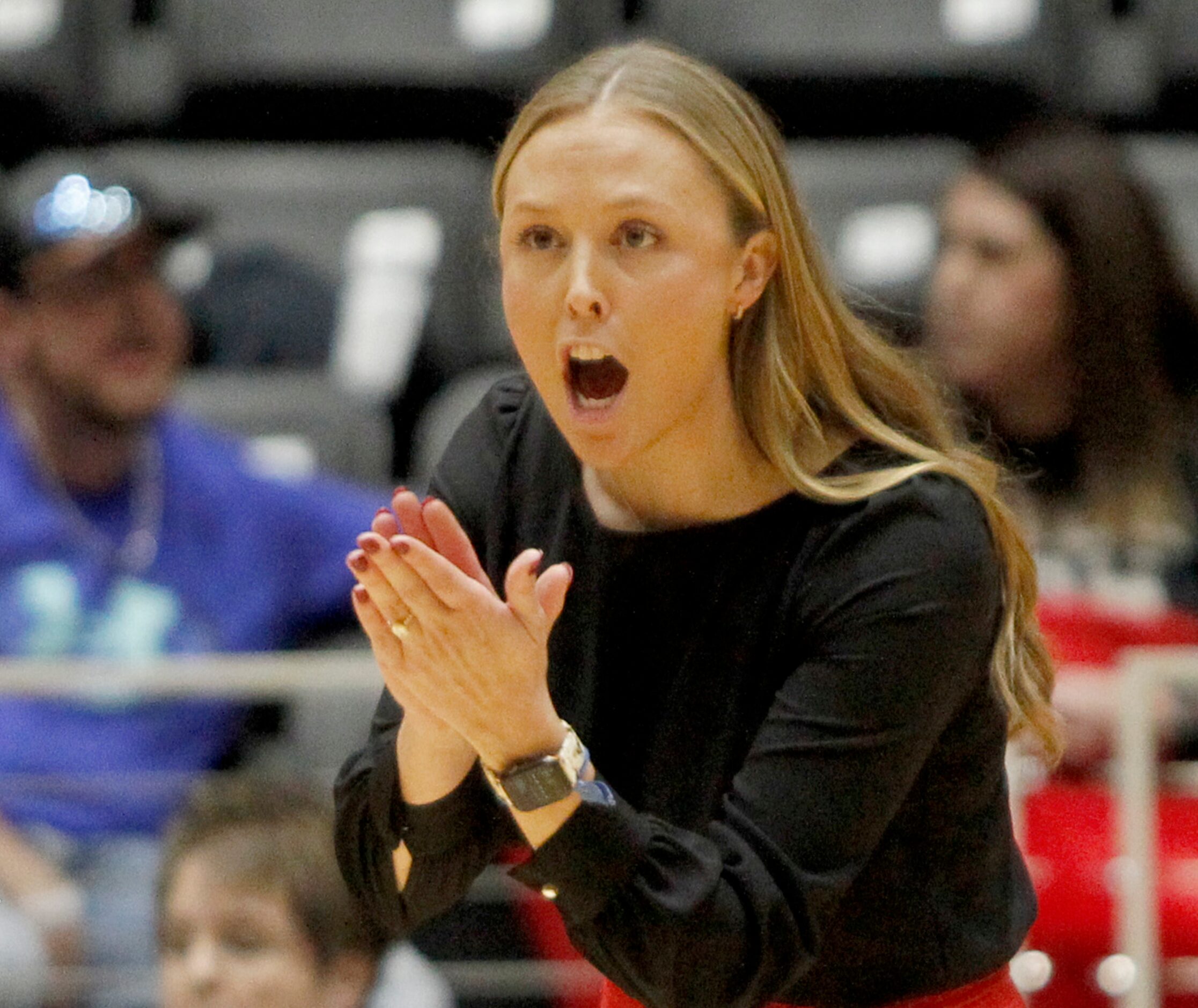 Lucas Lovejoy head coach Natalie Puckett encourages her players from the team bench area...