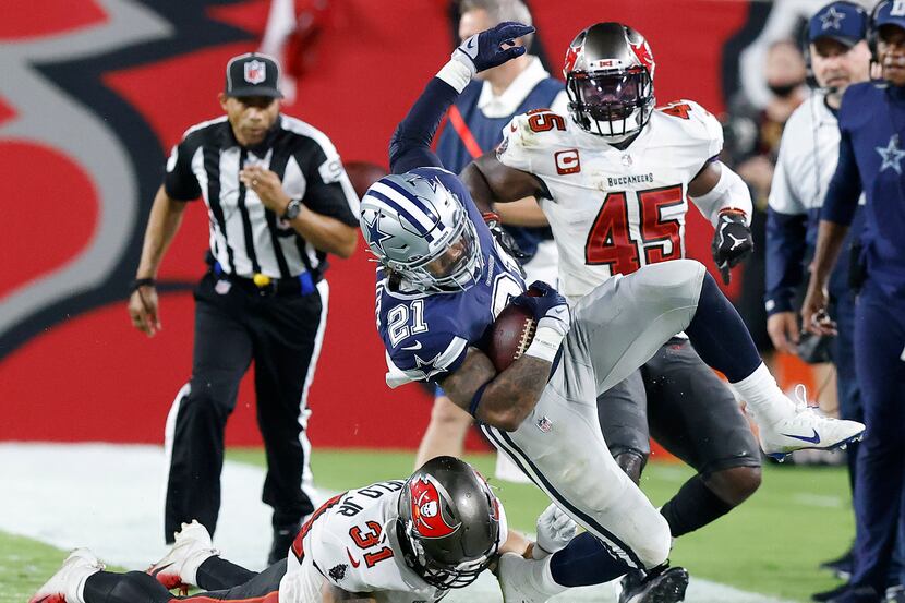 Dallas Cowboys running back Ezekiel Elliott (21) is knocked out of bounds by Tampa Bay...