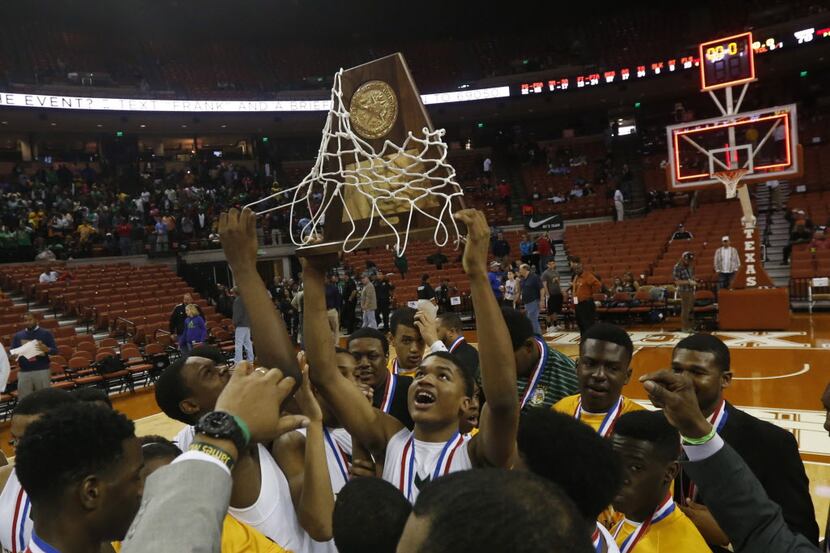 Dallas Madison forward Johnathan Turner (1) and teammates celebrate their championship in...