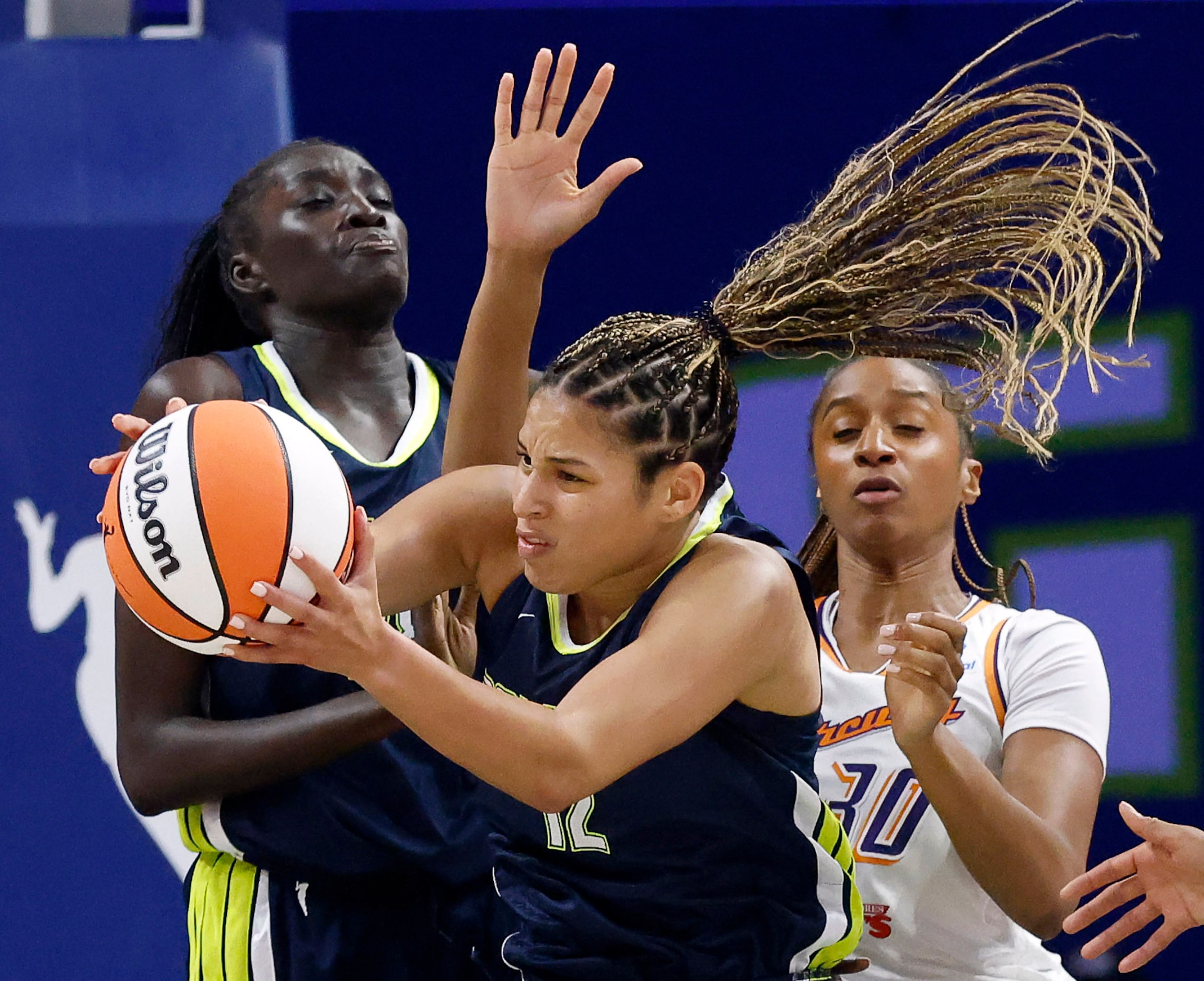 Dallas Wings guard Veronica Burton (12) comes down with a rebound against the Phoenix...