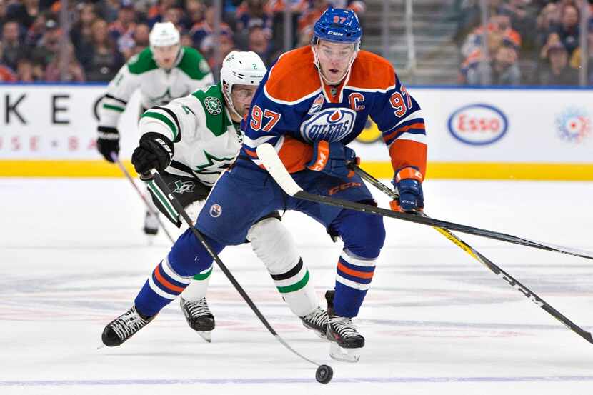 Dallas Stars' Dan Hamhuis (2) chases Edmonton Oilers' Connor McDavid (97) during the second...