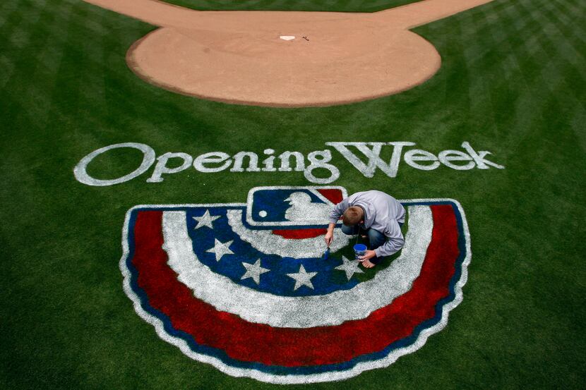 Steve Lord, assistant director of MLB Grounds for the Texas Rangers  paints the Opening Day...