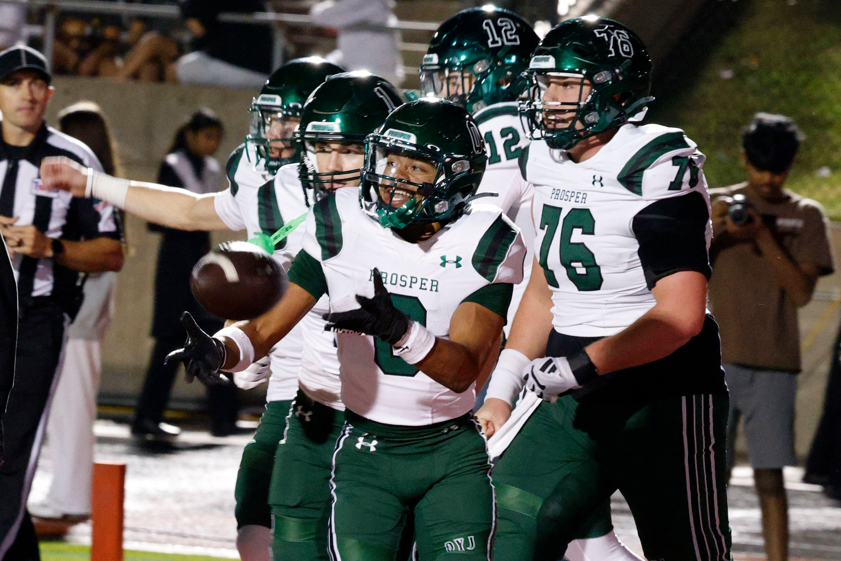 Prosper's Leo Anguiano (0), center, celebrates with his teammates after scoring a touchdown...