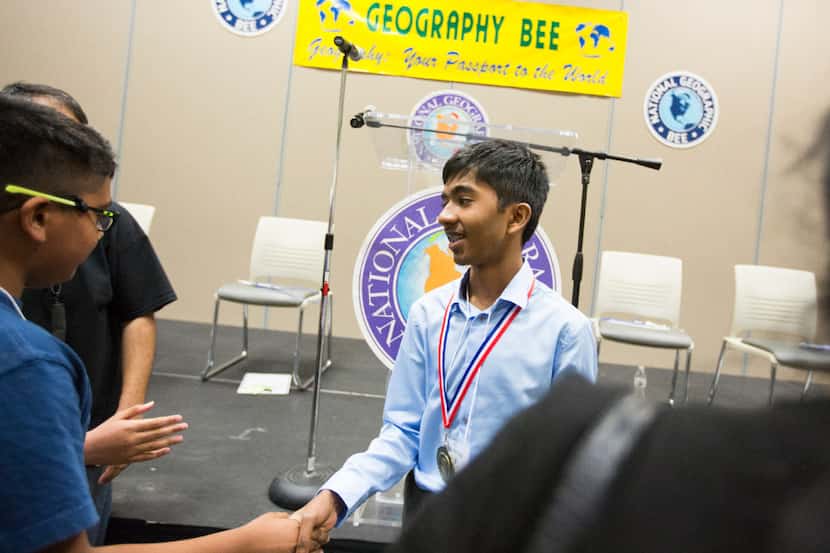 Pranay Varada, Texas' previous state champion, is congratulated after winning the final...