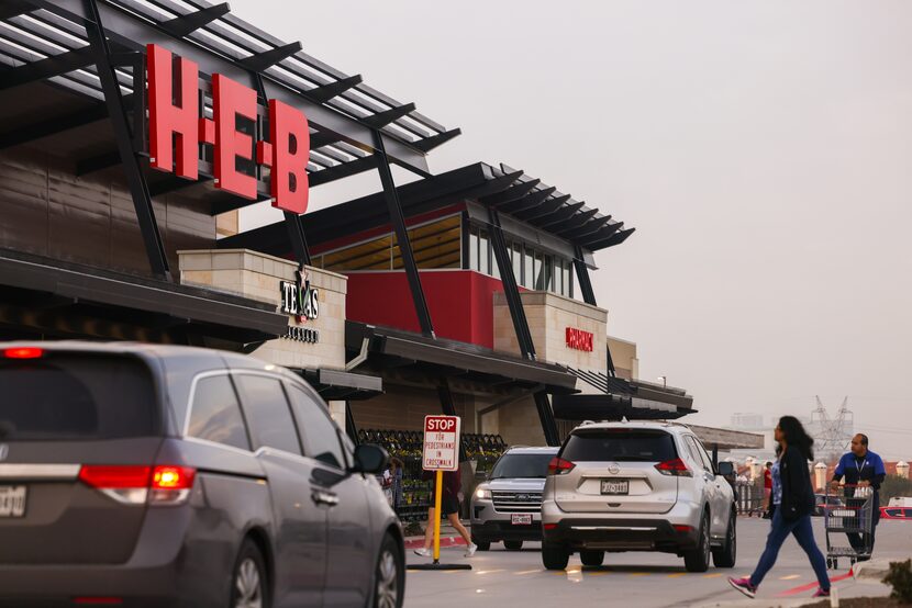 Shoppers move toward the H-E-B entrance in Plano on Dec. 7.