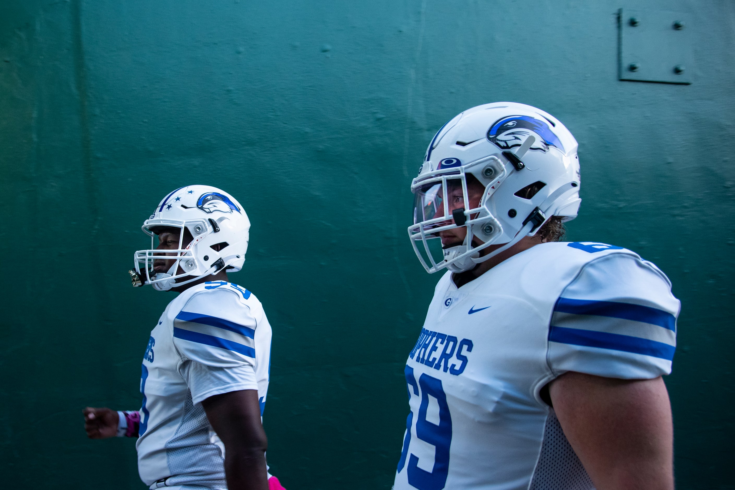 From left, Grand Prairie senior Zaylon Reed (99) and senior Hunter Carlise (69) walk down...